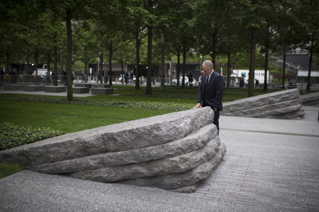 Jon Stewart next to a stone monolith at the 9/11 Memorial Glade dedication ceremony in May, 2019.