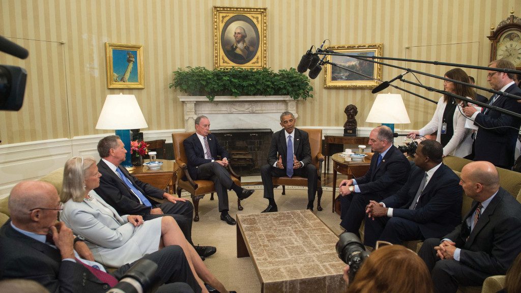 Photo of Mike discussing global trade deals with Obama and others.